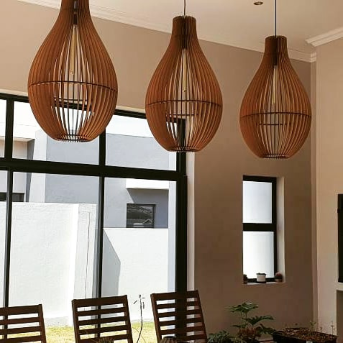 Honey Badger Vino Bottle-Shaped Pendant Light – three pendants in a room with large windows