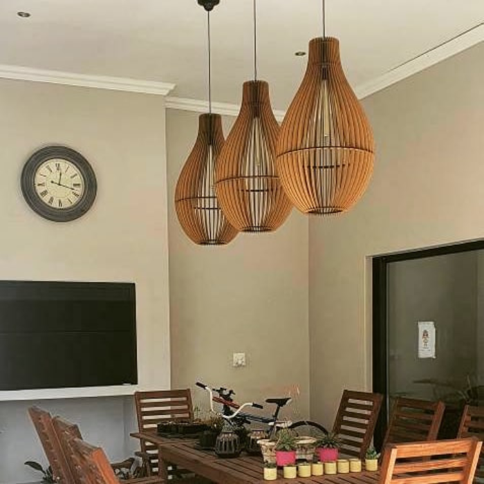 Honey Badger Vino Bottle-Shaped Pendant Light – three pendants above a meeting table