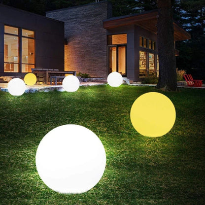 LED RGB Colour-Changing Ball Light – lit balls on a garden lawn at night