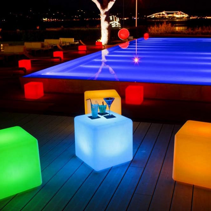 LED RGB Colour-Changing Light Cube – lit cubes beside a lit pool at night