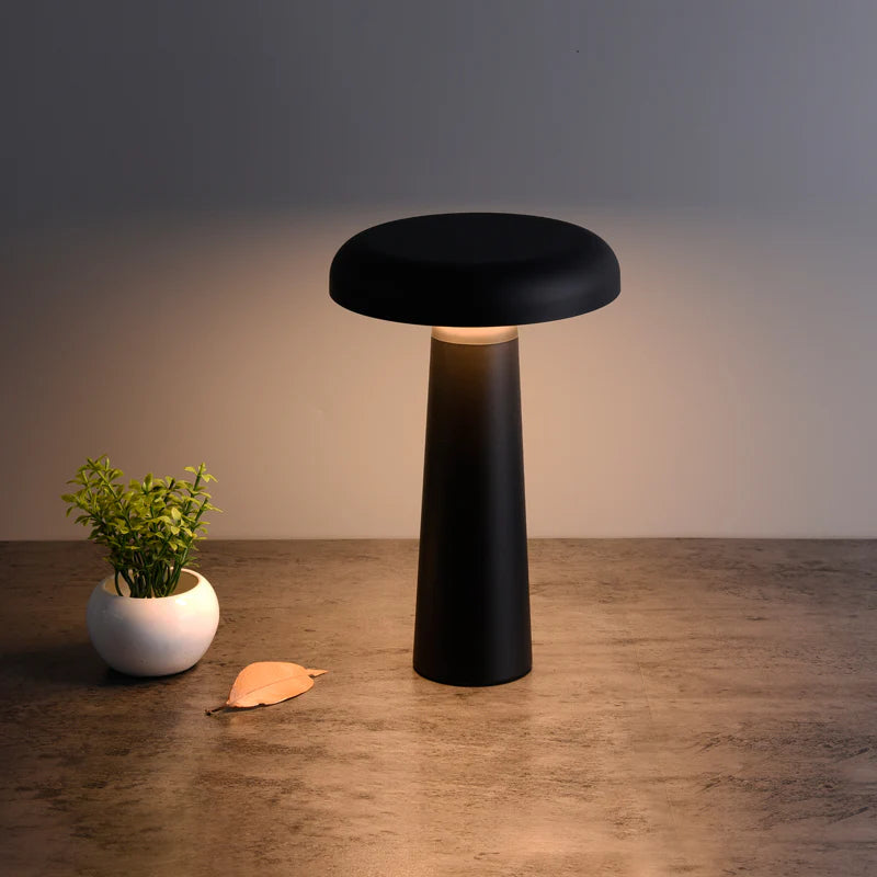 SPAZIO Boletus Rechargeable Dimmable Table Lamp – black lamp, lit, on a wooden table