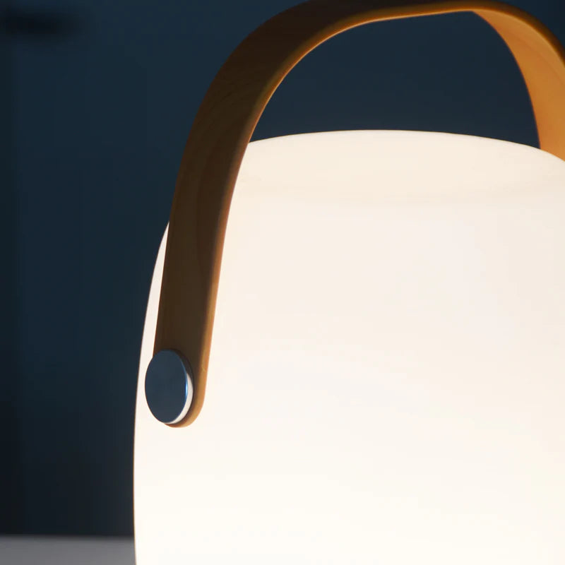 SPAZIO Bonbon 2 Rechargeable Table Lamp – close-up of the lit lamp and tan carry handle