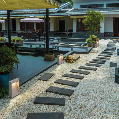 SPAZIO Cinder B LED Bollard – lit bollard beside a garden path at dusk
