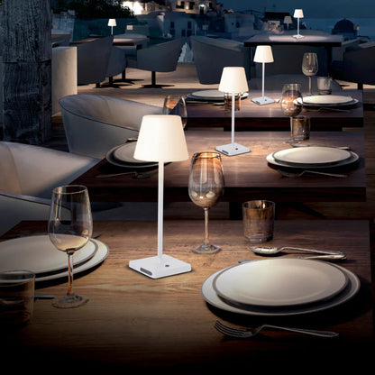 SPAZIO Lolly Rechargeable Outdoor Table Lamp – lit lamps on an outdoor dining table at dusk
