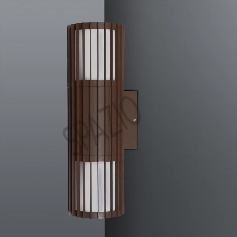 SPAZIO Paso Doblo Up & Down Outdoor Wall Light – Corten finish on a grey wall