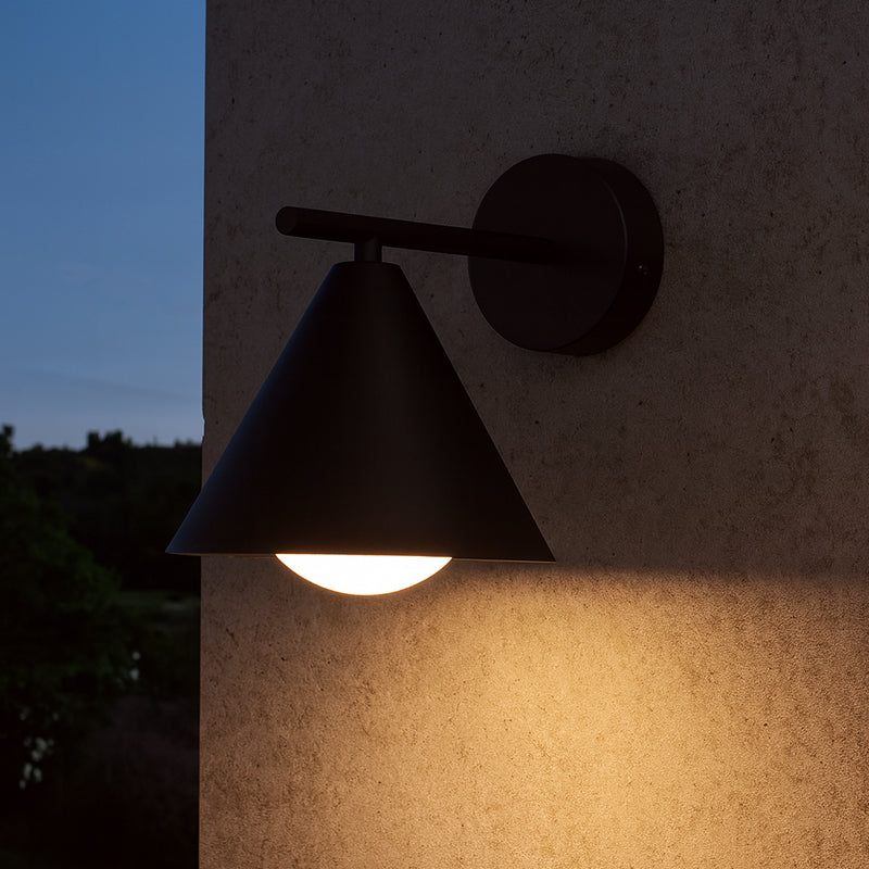 SPAZIO Railroad 2 Outdoor Wall Light – lit on an outdoor wall at dusk