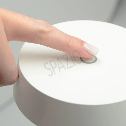 SPAZIO Slender Rechargeable Table Lamp – finger pressing the touch switch on top