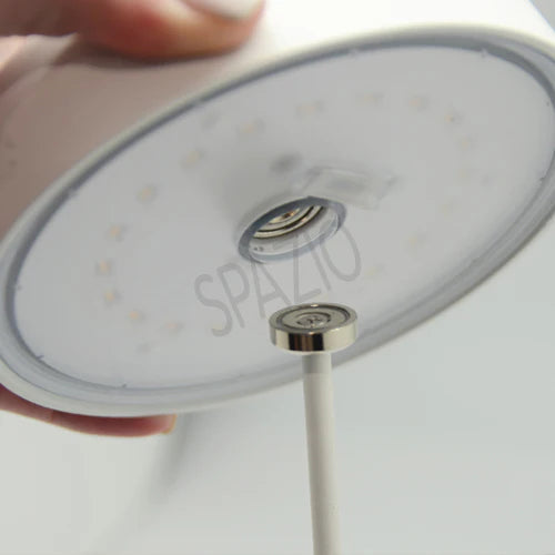 SPAZIO Slender Rechargeable Table Lamp – hand lifting the head, showing the LEDs underneath