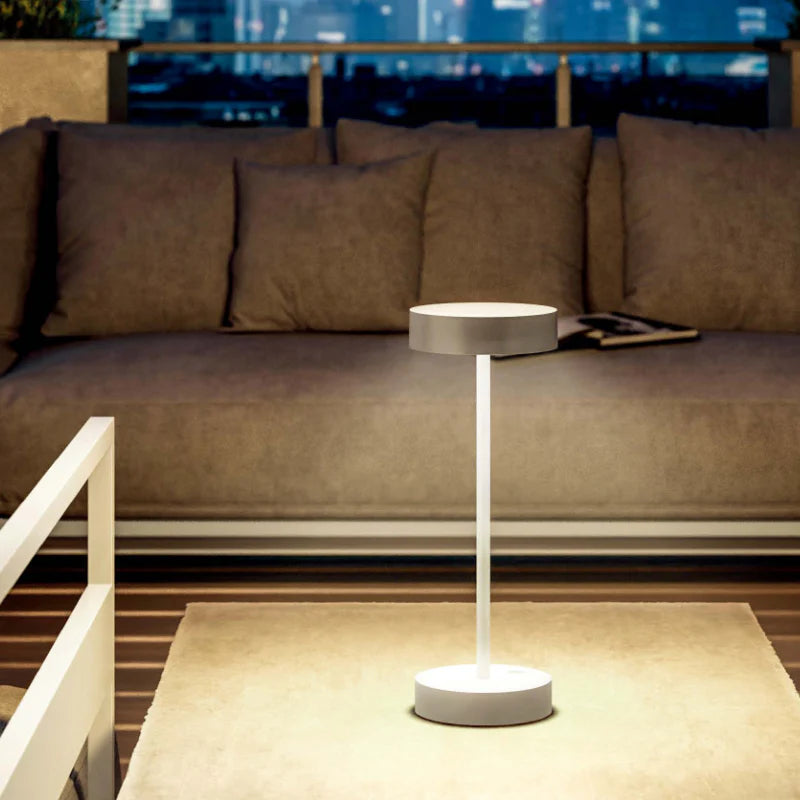 SPAZIO Standy Mini Rechargeable Desk Lamp – lamp on an outdoor table at dusk