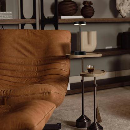 SPAZIO Standy Mini Rechargeable Desk Lamp – lamp on a side table beside a leather chair