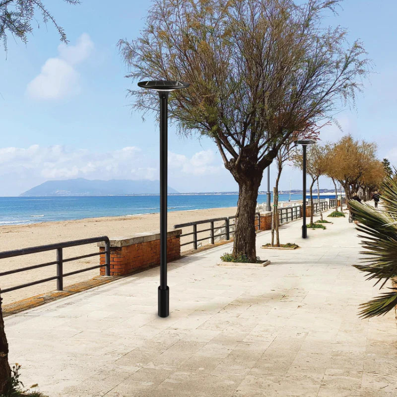 SPAZIO Sunflower Solar LED Post Top – post tops lining a seaside promenade