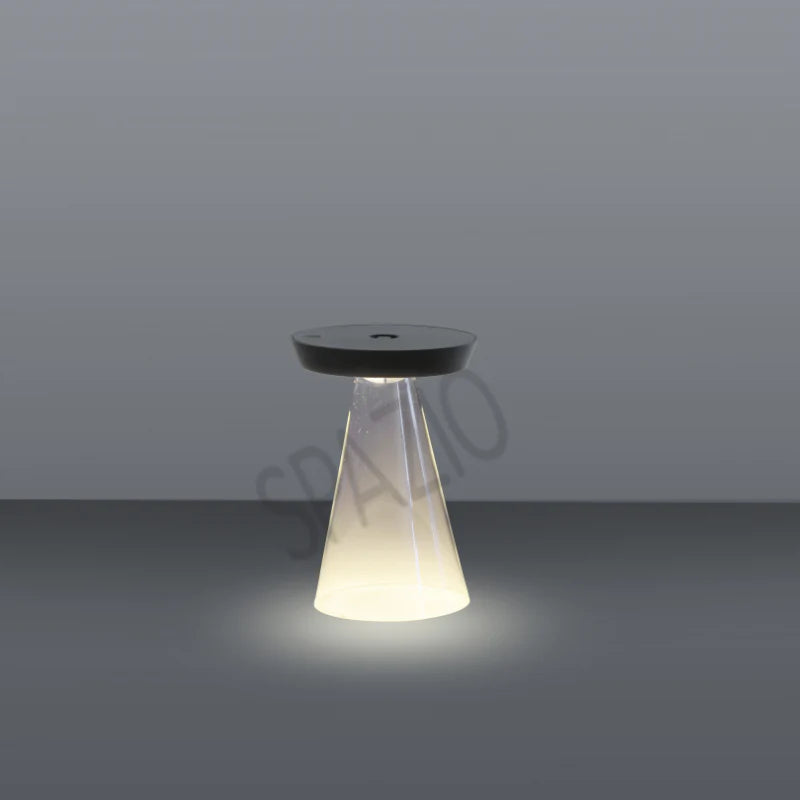 SPAZIO Torus Glass Rechargeable Desk Lamp – lit lamp on a grey background