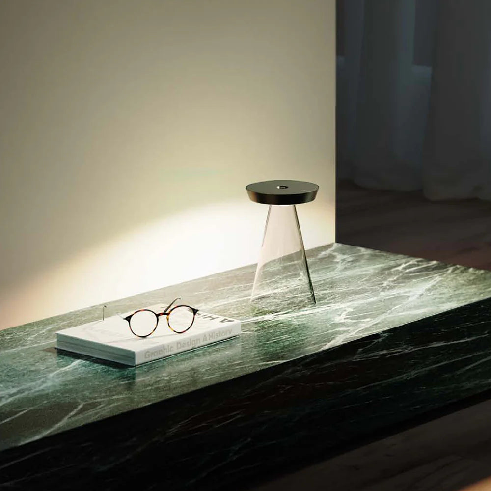 SPAZIO Torus Glass Rechargeable Desk Lamp – lit lamp on a marble table beside glasses