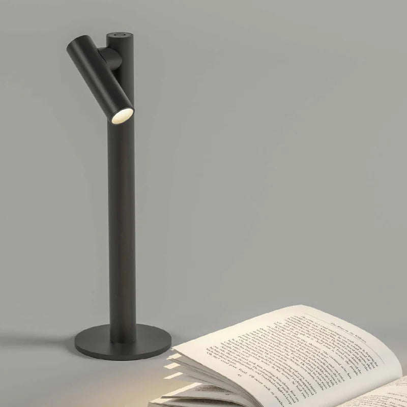 SPAZIO Zoom Rechargeable Table Lamp – dark lamp beside an open book