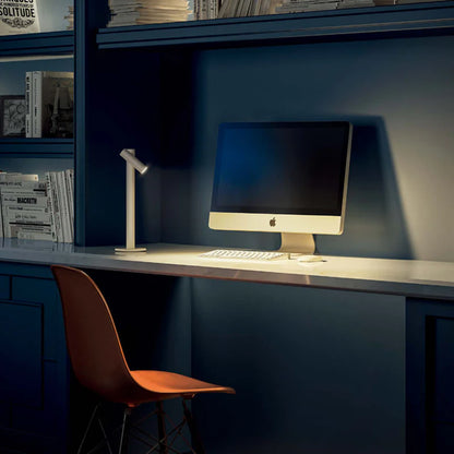 SPAZIO Zoom Rechargeable Table Lamp – lit lamp on a desk beside a computer