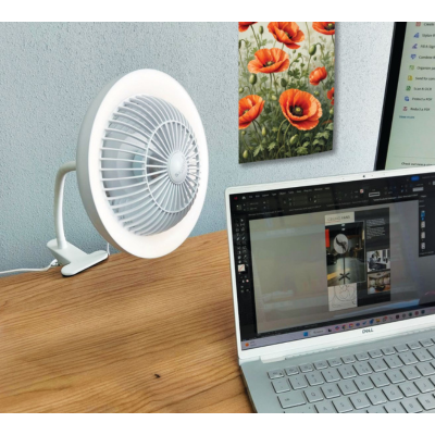 Synerji Rechargeable Clip Fan with LED Light – clipped to a desk beside a laptop