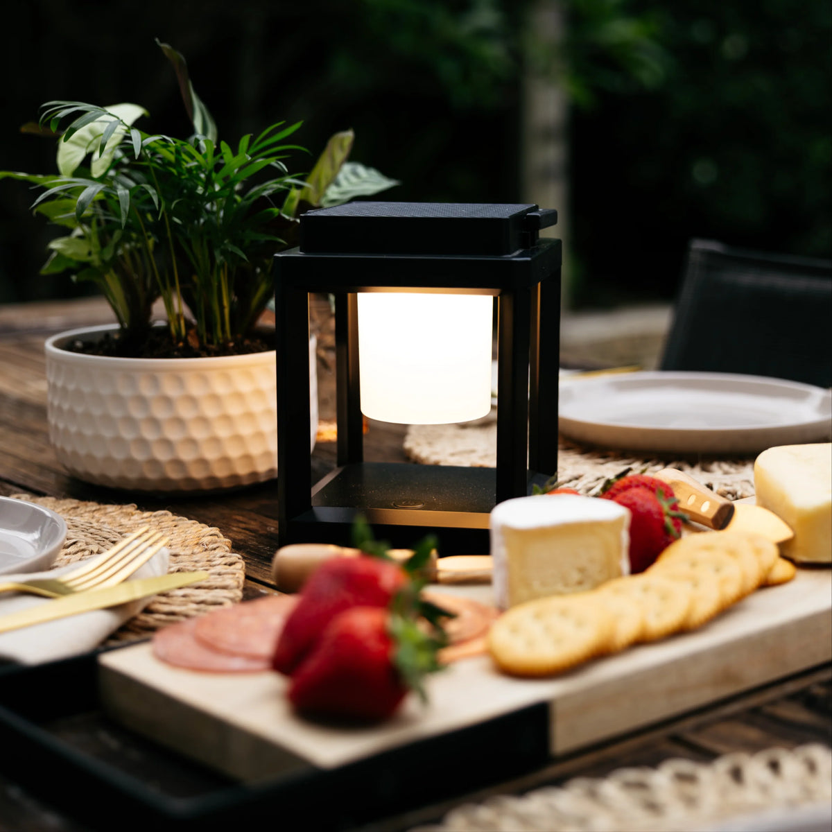 Synerji Solar LED Lantern – lit lantern on a table with food